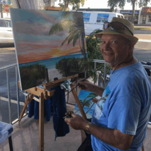 Lloyd Dobson Artist sitting at his easel
