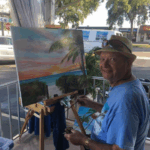 Lloyd Dobson Artist painting live on the patio of Mon's Steamer Bar