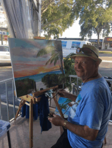 Lloyd Dobson Artist painting live on the patio of Monk's Steamer Bar