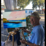 Lloyd Dobson Artist at Monk'e Steamer Bar Patio painting Sunset Pier Tiki Bar in Key West Florida