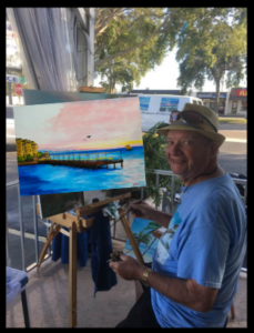 Lloyd Dobson Artist at Monk'e Steamer Bar Patio painting Sunset Pier Tiki Bar in Key West Florida