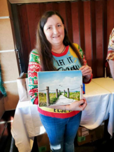 Kelley Miller holding her latest oil painting by Lloyd Dobson Artist